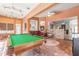 Spacious living room with pool table and brick accent wall, perfect for entertaining guests at 6 Greenvale Dr, Ormond Beach, FL 32174