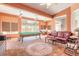 Spacious recreational room with brick floors, pool table, leather sofa, and natural light at 6 Greenvale Dr, Ormond Beach, FL 32174