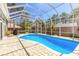 Inviting screened-in pool with brick pavers, perfect for relaxation and outdoor enjoyment at 6 Greenvale Dr, Ormond Beach, FL 32174
