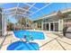 Luxurious screened-in pool area with a spa, lush landscaping, and ample space for outdoor living at 6 Greenvale Dr, Ormond Beach, FL 32174