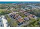 Aerial view showing townhome community with nearby tennis courts, golf course, and coastal scenery at 60 N Halifax Dr # 1050, Ormond Beach, FL 32176