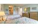 Comfortable bedroom featuring twin beds, a closet, and a doorway, offering a cozy retreat at 60 N Halifax Dr # 1050, Ormond Beach, FL 32176