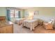 Cozy bedroom with twin beds, soft carpet, and a bright window creating a relaxing atmosphere at 60 N Halifax Dr # 1050, Ormond Beach, FL 32176