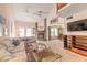 Bright living room with a brick fireplace, high ceilings, and access to the dining area at 60 N Halifax Dr # 1050, Ormond Beach, FL 32176
