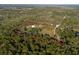 Desirable aerial view of wooded acreage featuring a home with an outbuilding, property line outlined in red at 600 Tabatha Dr, Osteen, FL 32764