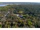 Attractive aerial view of wooded acreage featuring a home with an outbuilding at 600 Tabatha Dr, Osteen, FL 32764