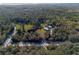 Expansive aerial view of wooded acreage with home and outbuilding at 600 Tabatha Dr, Osteen, FL 32764