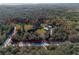 Aerial view of wooded acreage with home and outbuilding with property line outlined in red at 600 Tabatha Dr, Osteen, FL 32764