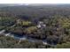 Lovely aerial view of wooded acreage featuring a home with an outbuilding at 600 Tabatha Dr, Osteen, FL 32764