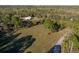An aerial shot of grass, trees, a fence, and a road at 600 Tabatha Dr, Osteen, FL 32764