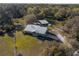 Beautiful aerial view of a brick home with metal roof, large lot, barn and storage shed at 600 Tabatha Dr, Osteen, FL 32764