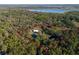 Lovely aerial view of wooded acreage featuring a home with an outbuilding, property line outlined in red at 600 Tabatha Dr, Osteen, FL 32764