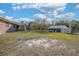 Lush backyard featuring a shed, screened-in porch, and verdant greenery at 600 Tabatha Dr, Osteen, FL 32764