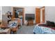 This bedroom has carpet and contains a bed, television and shelving at 600 Tabatha Dr, Osteen, FL 32764