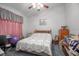Cozy bedroom with decorative curtains and a bed with patterned bedspread at 600 Tabatha Dr, Osteen, FL 32764