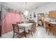 Open dining area with a view into the bedroom, tile floors, and an elegant chandelier at 600 Tabatha Dr, Osteen, FL 32764