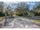 Long gravel driveway leading to the property, framed by a rustic wooden fence and lush greenery at 600 Tabatha Dr, Osteen, FL 32764