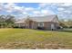 Charming single-story brick home featuring a well-manicured lawn and a metal roof at 600 Tabatha Dr, Osteen, FL 32764