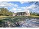 Exterior view of brick home with metal roof, sunroom, and spacious yard at 600 Tabatha Dr, Osteen, FL 32764