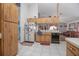 Another view of this kitchen features tile flooring, wood cabinets, and open shelving at 600 Tabatha Dr, Osteen, FL 32764