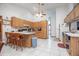 Bright kitchen features tile floors, wooden cabinets, and an eat-in counter with seating at 600 Tabatha Dr, Osteen, FL 32764