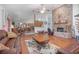 Expansive living room showcasing exposed brick fireplace and views into kitchen at 600 Tabatha Dr, Osteen, FL 32764