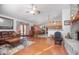 Open-concept living room featuring brick fireplace and hardwood style floors at 600 Tabatha Dr, Osteen, FL 32764