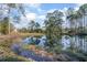 Scenic view of a tranquil pond reflecting the surrounding trees, creating a peaceful atmosphere at 600 Tabatha Dr, Osteen, FL 32764