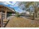 Wide shot of the property showcasing an open shed and brick home at 600 Tabatha Dr, Osteen, FL 32764