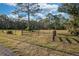 Spacious grassy area enclosed by a metal gate and fencing, ideal for livestock or recreational use at 600 Tabatha Dr, Osteen, FL 32764