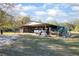 Large shed with vehicles, equipment, and metal roof at 600 Tabatha Dr, Osteen, FL 32764