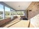 Spacious sunroom with brick walls, large windows, and a door to the outside at 600 Tabatha Dr, Osteen, FL 32764