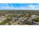 Wide aerial shot of a residential community with lush trees and a distant cityscape view at 617 S Flamingo Dr, Holly Hill, FL 32117