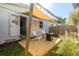 Backyard featuring a wooden deck with overhead sunshade, string lights, and two Adirondack chairs at 617 S Flamingo Dr, Holly Hill, FL 32117