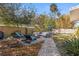 Spacious backyard featuring lounge chairs, a fire pit, well-manicured landscaping, and a refreshing pool at 617 S Flamingo Dr, Holly Hill, FL 32117