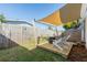 Cozy backyard patio with a shade and two Adirondack chairs and fire pit, perfect for relaxing outdoors at 617 S Flamingo Dr, Holly Hill, FL 32117