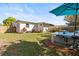 Large backyard featuring an above-ground pool, outdoor seating, and well-maintained landscaping for outdoor enjoyment at 617 S Flamingo Dr, Holly Hill, FL 32117