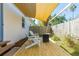 Charming backyard with a deck, shade sail, Adirondack chairs, and lush landscaping at 617 S Flamingo Dr, Holly Hill, FL 32117