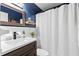 Bathroom featuring dark blue walls, a modern vanity with a white sink, and a white shower curtain at 617 S Flamingo Dr, Holly Hill, FL 32117