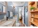Inviting bathroom with gray walls, granite counters, white vanity and views into the primary bedroom at 617 S Flamingo Dr, Holly Hill, FL 32117