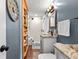 Gray and white bathroom featuring a natural wood shelving unit and a glass enclosed shower at 617 S Flamingo Dr, Holly Hill, FL 32117