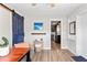 Inviting dining area with a dark barn door, wood floors, and an adjacent kitchen space at 617 S Flamingo Dr, Holly Hill, FL 32117