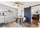 Bright dining area featuring a modern table set, ceiling fan, and stylish barn door entrance at 617 S Flamingo Dr, Holly Hill, FL 32117