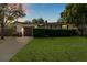 Well-maintained home with a lush lawn, mature trees, and a welcoming driveway at 617 S Flamingo Dr, Holly Hill, FL 32117