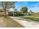 Lovely single-story home with a lush green lawn, large tree, and paved driveway at 617 S Flamingo Dr, Holly Hill, FL 32117