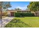 Charming single-story home with a well-manicured lawn, mature trees, and a private driveway at 617 S Flamingo Dr, Holly Hill, FL 32117