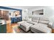Open living room with hardwood floors, gray sectional sofa, and an open view to the kitchen at 617 S Flamingo Dr, Holly Hill, FL 32117