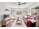 Cozy living room featuring a comfortable sofa, bright window, and modern decor at 617 S Flamingo Dr, Holly Hill, FL 32117