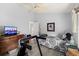 Bright bedroom with a ceiling fan, dresser, and an open door to another room at 6408 Whit Ct, Port Orange, FL 32128