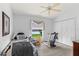 Neutral bedroom featuring a treadmill, ceiling fan, and closet for extra storage at 6408 Whit Ct, Port Orange, FL 32128